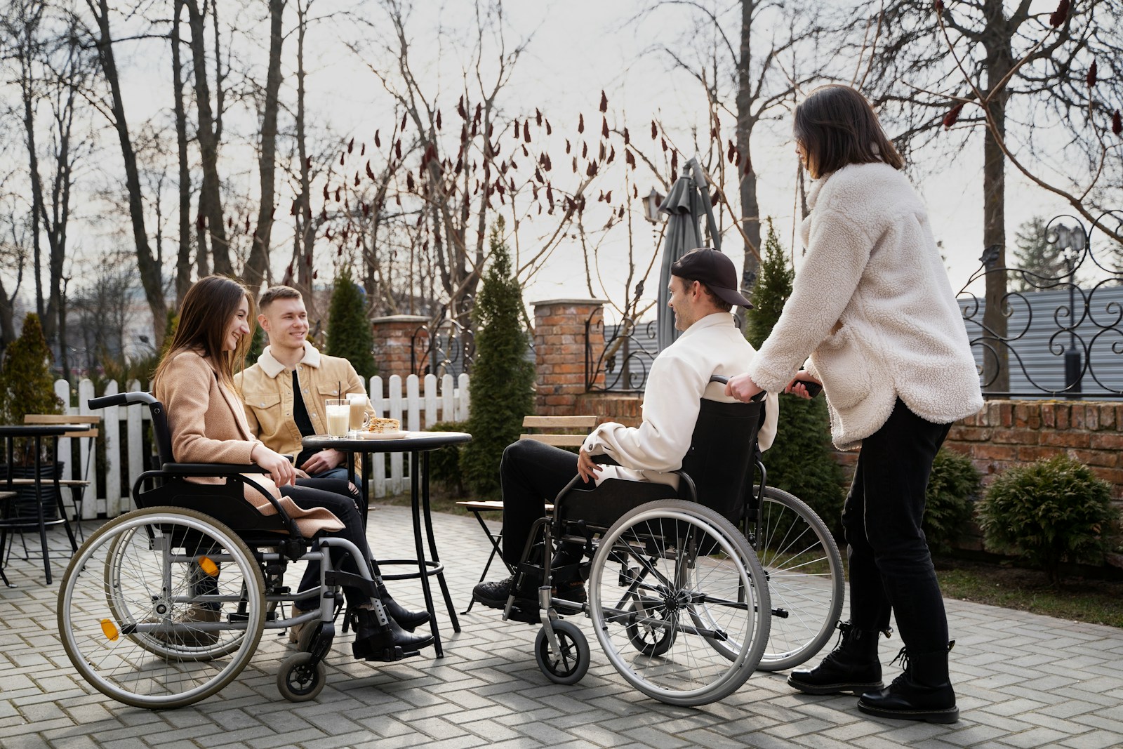 A group of people in wheelchairs sitting around a table